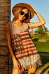 American flag fringe tank top worn by a woman, featuring a vintage flag graphic and trendy fringe hem on a sunny day.
