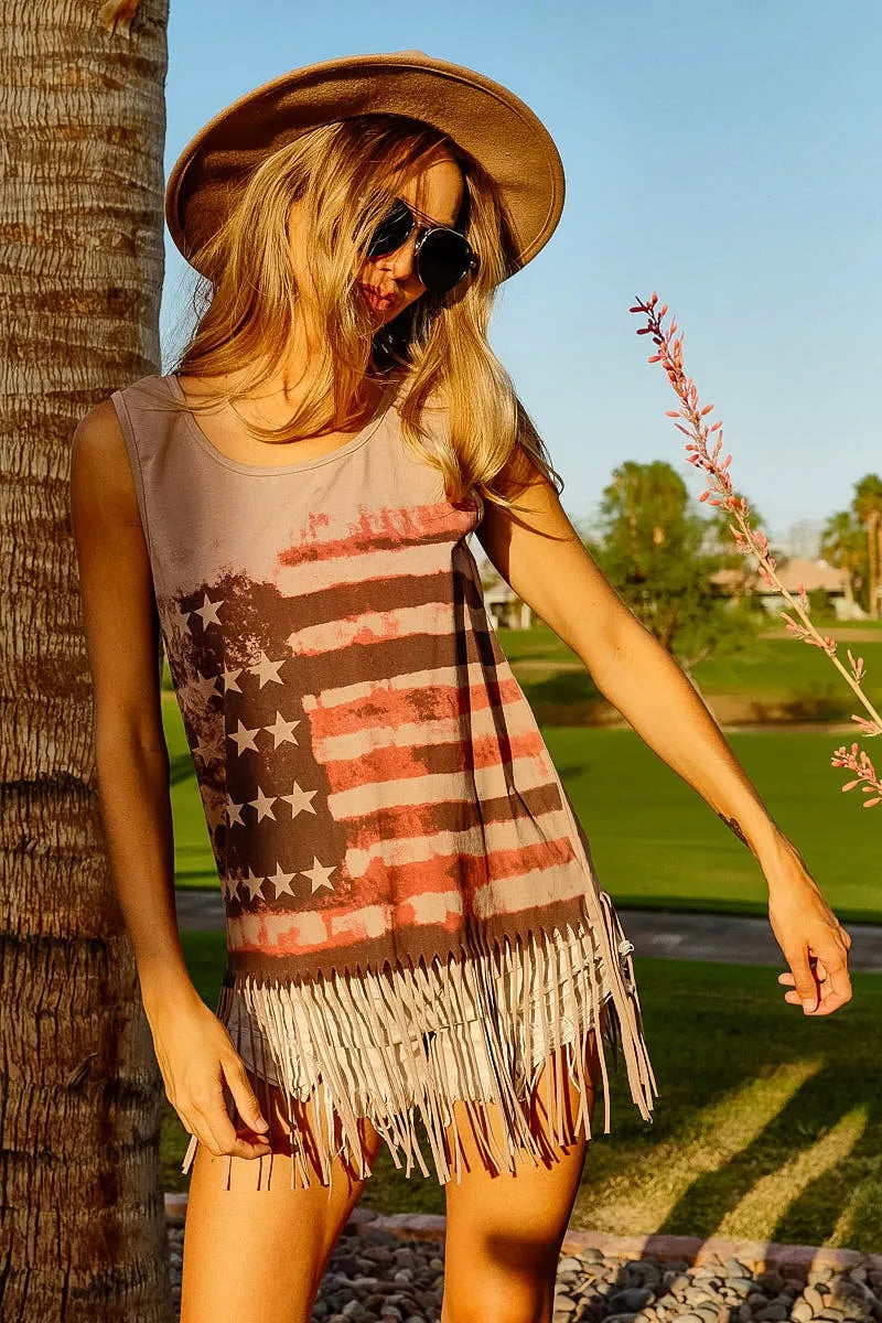 American flag fringe tank top on a woman outdoors, showcasing patriotic style and trendy fringe design.