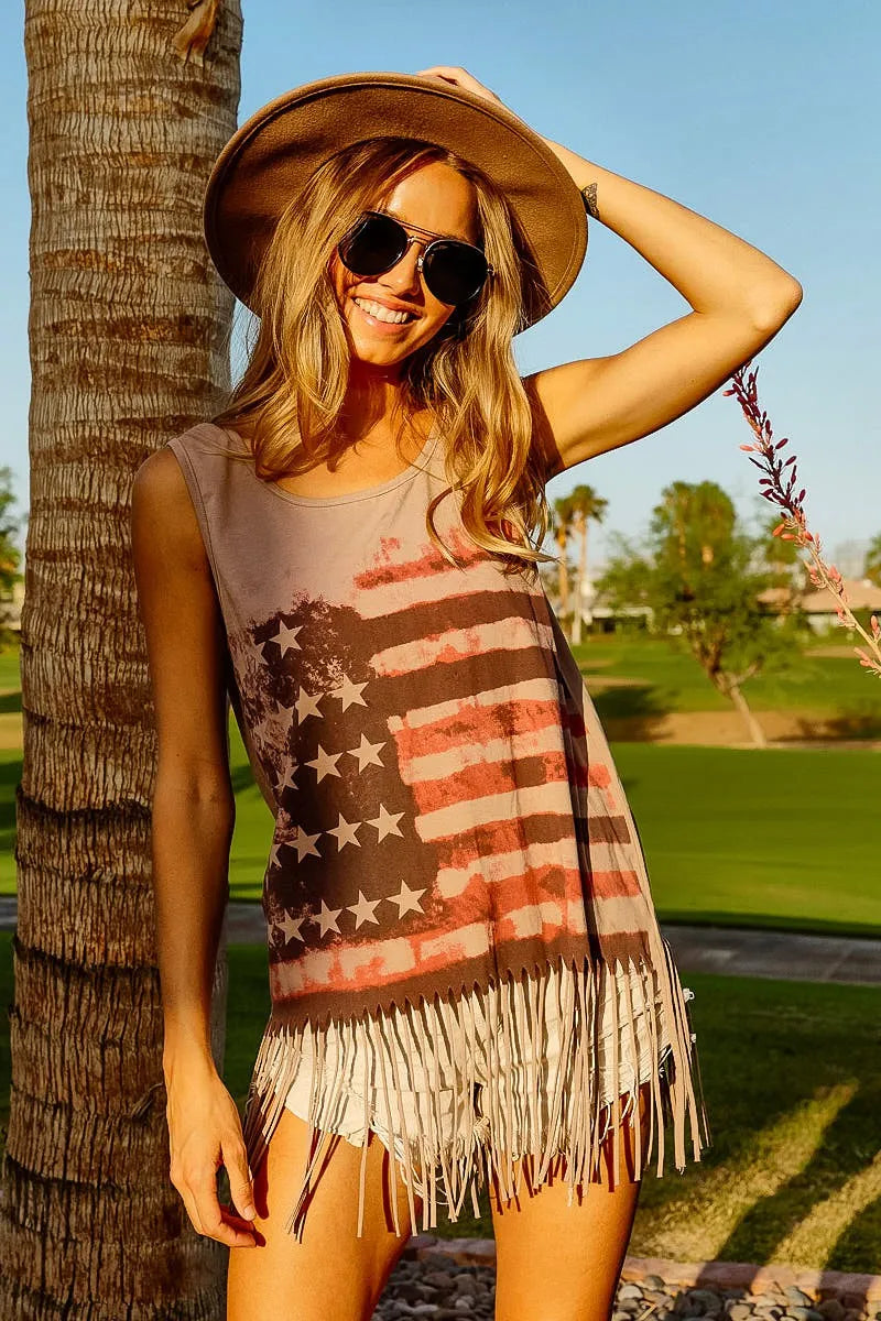 American flag fringe tank top for women modeled outdoors, featuring vintage flag graphic and fringe hem, perfect for summer.